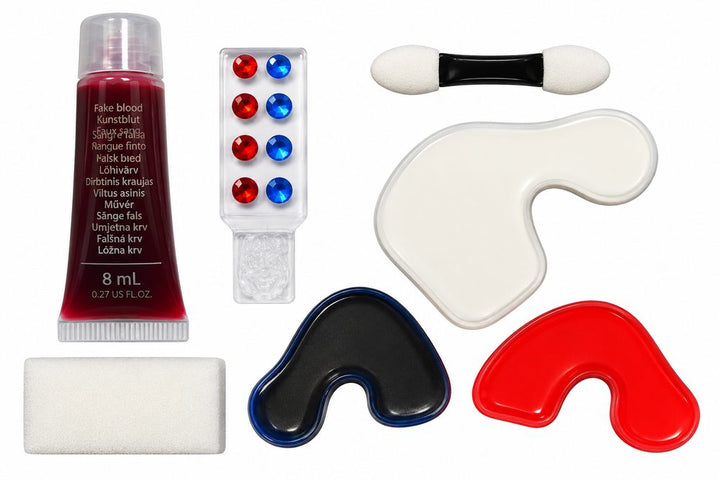 Inhoud van de clown schminkset: nepbloed, rode en blauwe steentjes, witte, rode en blauwe schmink, spons en applicator.